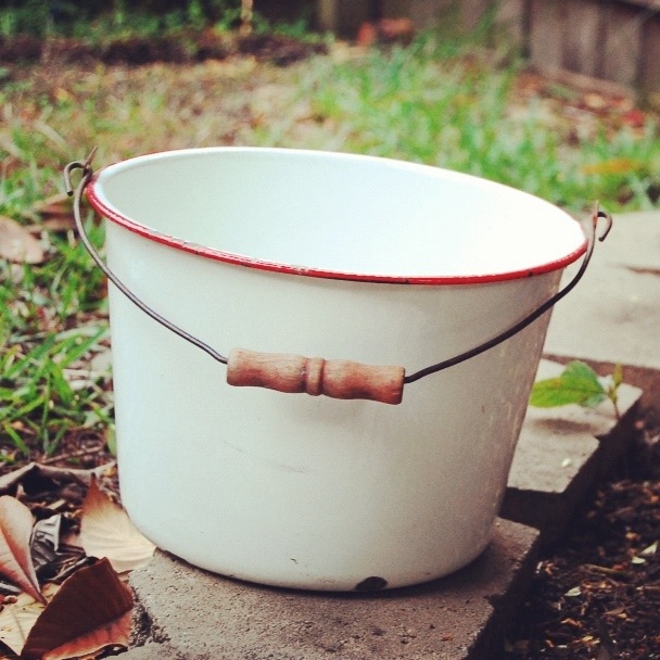 red and white enamelware bucket